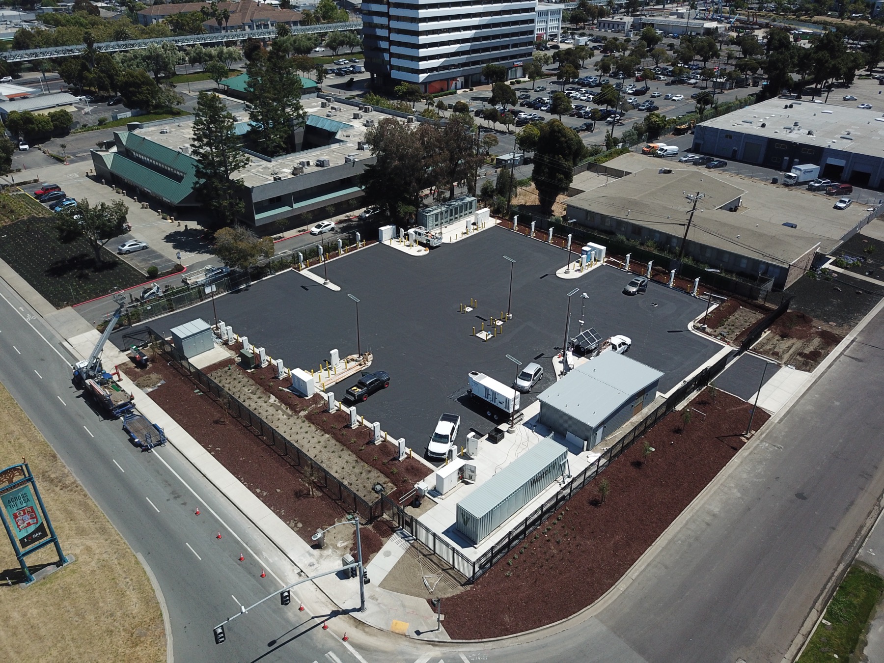 Aerial view of the Oakland charging site with paved drive aisles, charging equipment, and completed site improvements.